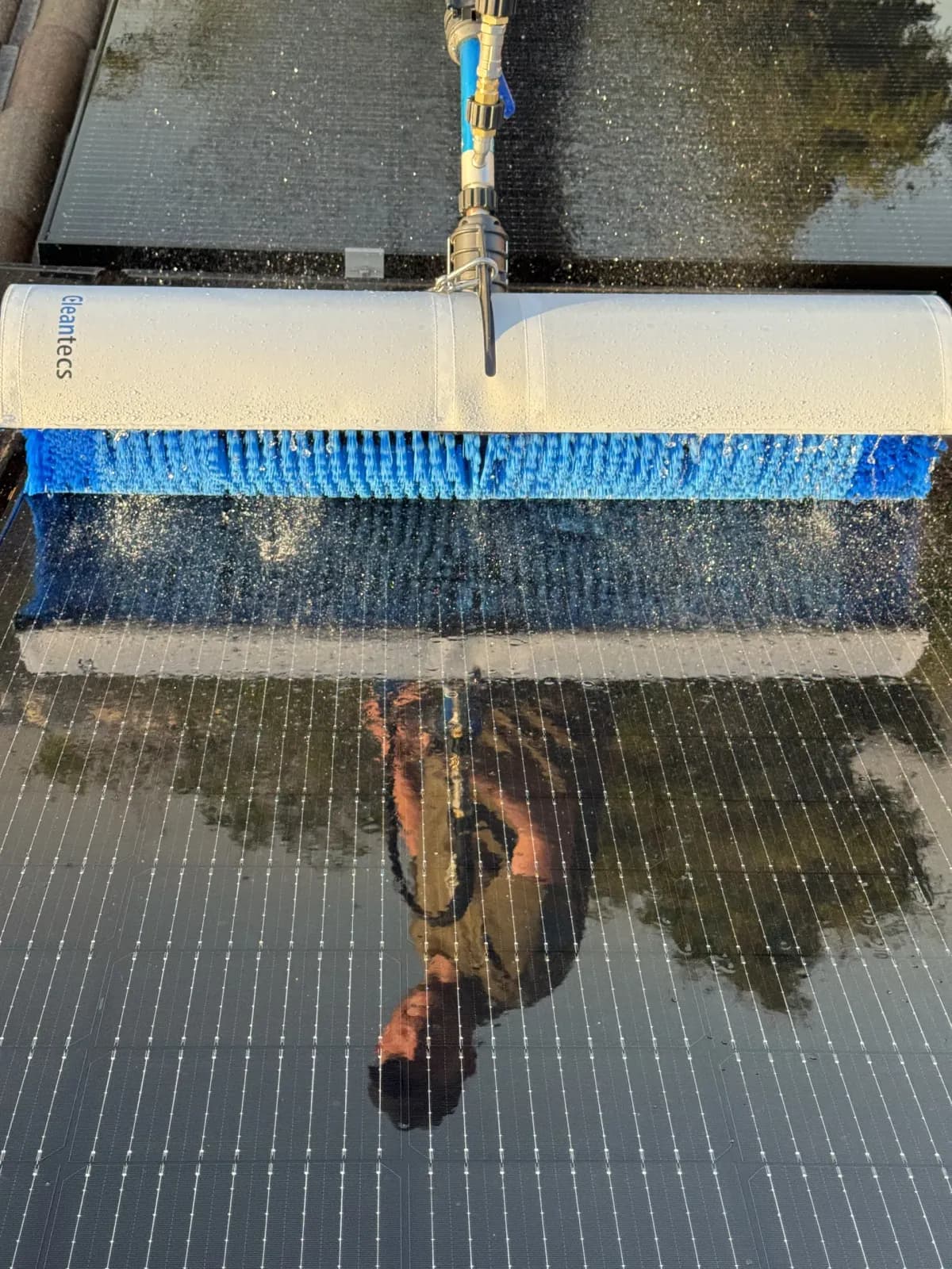 HelioClean technician using purified RO/DI water system on solar panels in Pretoria