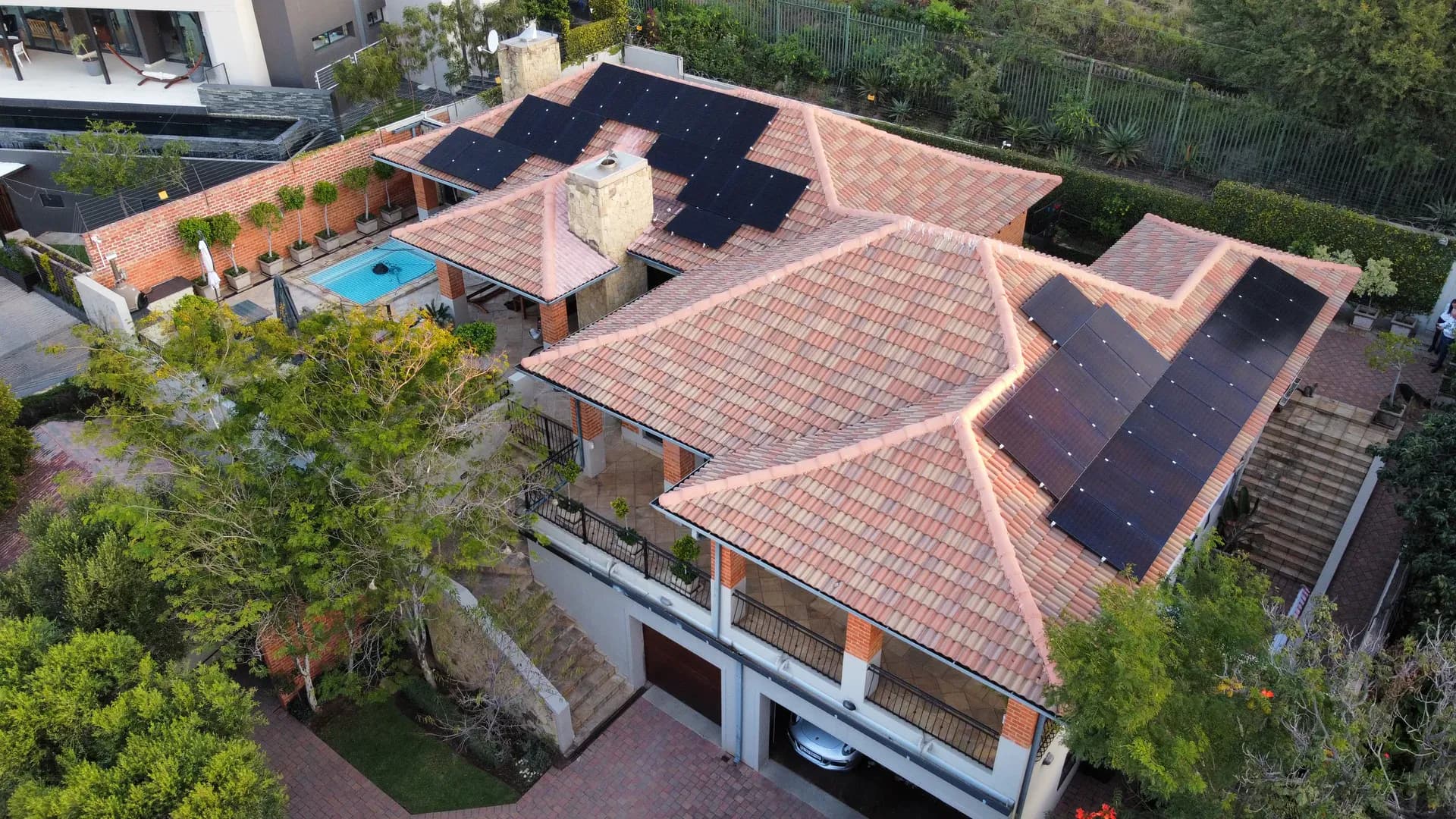 Clean solar panels on a Pretoria-area home under a bright Highveld sky — professional residential service