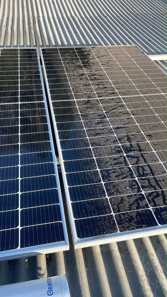 Half-cleaned solar panel showing the contrast between dust and a fresh Cleantecs brush pass