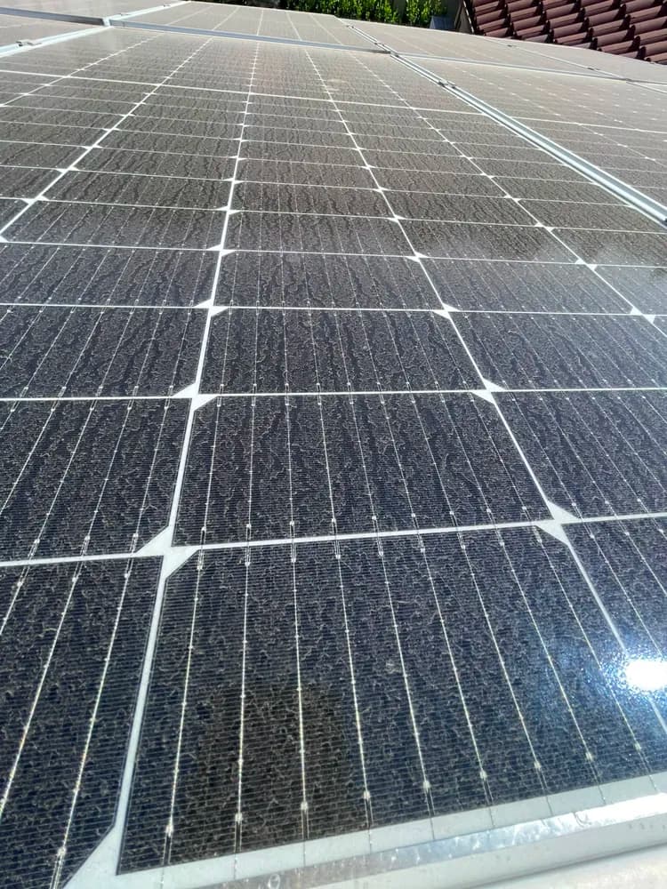 Close-up of solar panels heavily coated in streaked Highveld dust before cleaning