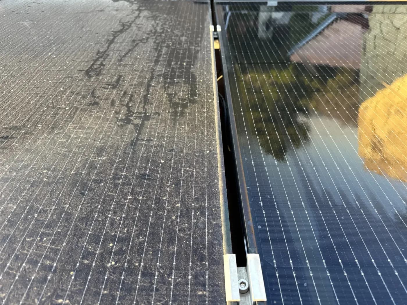 Solar array half cleaned — dirty panels next to freshly cleaned panels