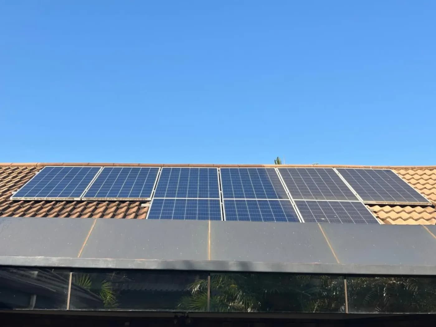 Side-by-side view of a dirty solar panel and the same surface after cleaning