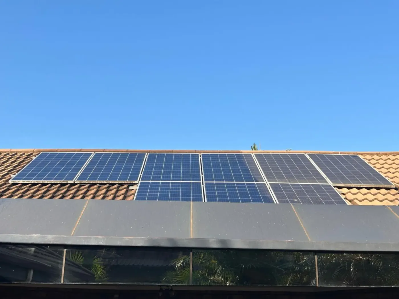 Side-by-side comparison of a dirty solar panel next to a freshly cleaned one